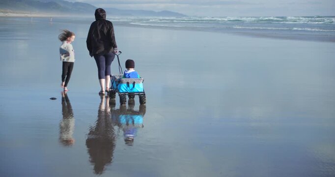 Mother Walking on a Beach with Kids