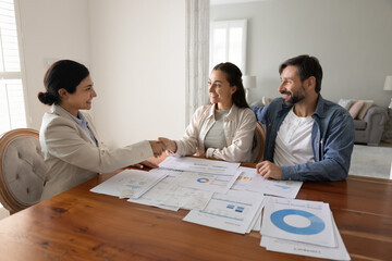 Financial advisor or investment consultant handshake with couple during formal meeting, getting...