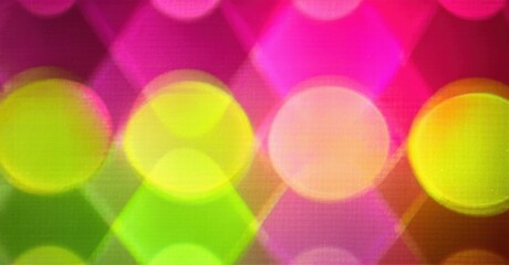 Bright circles overlap, creating vibrant pink, yellow, green hues. Bokeh effect dominates image, soft focus present. Background dark.