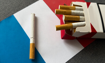 French flag with cigarettes and cigars. Tobacco Industry concept.