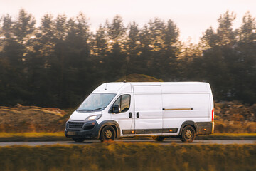 Modern transport van on highway in nature