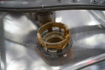 Grease clogged drain filter inside dishwasher