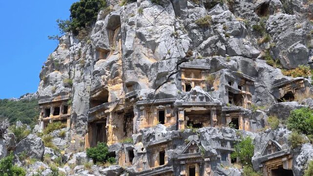Rock-cut tombs of the ancient Lycian necropolis. Myra is an antique town in Lycia where the small town of Kale (Demre) Turkey. Close-up of rock cut tomb grave.