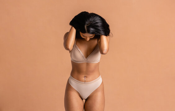 Young Woman Looking Down Holding Hair