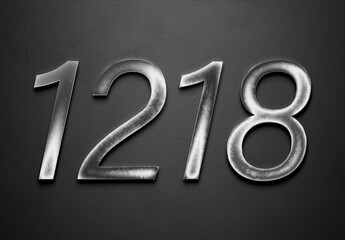 Chrome metal 3D number design of 1218 on grey background.