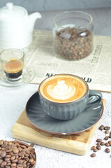 Cup of hot cappuccino coffee with beautiful latte art in a beautiful glass on the table