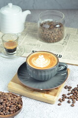 Cup of hot cappuccino coffee with beautiful latte art in a beautiful glass on the table