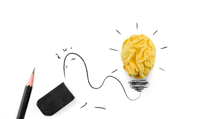 Concept of creative ideas and inspiration. Crumpled colored paper yellow lightbulb shape, pencil,...