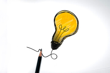 Pencil and drawing yellow light bulb  isolated on white background. Concept of creative ideas and...