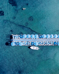 Resort beach with people sunbathing and swimming in clear sea water on sunny day, Marmaris, Türkiye