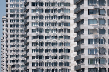 Row of same high rise boring brutalist grey concrete office buildings on sunny day, Moscow, Russia