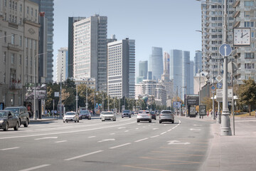 Wide avenue New Arbat between high rise buildings and skyscrapers of City on sunny summer day, Moscow