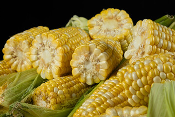 Detailed fresh raw corn cobs with natural texture close-up.