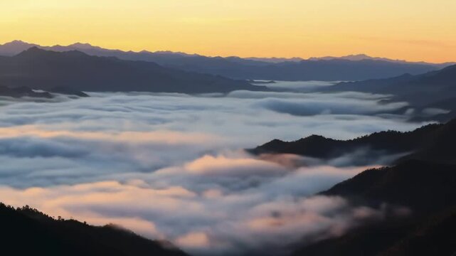 Mountain peaks emerge from a sea of clouds at sunrise, creating a breathtaking, atmospheric landscape with golden hues.