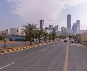 Financial District in Riyadh, Saudi Arabia, showcases towering skyscrapers and busy streets, driving global trade and economic growth in daylight bustle.
