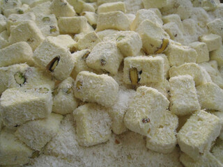Traditional Turkish Delight with Coconut and Pistachio Stacked Close Up