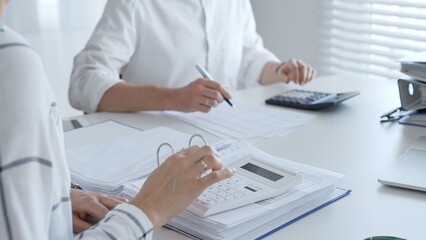 Close up of a calculator on financial documents, with an accountant hands working with, finance, and tax preparation. Audit and taxes in business