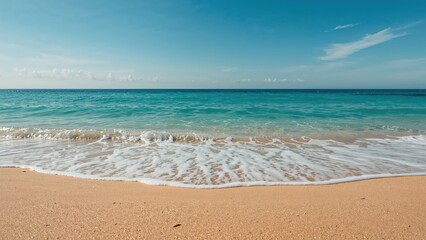Fototapeta premium Seaside view featuring sand and rolling waves