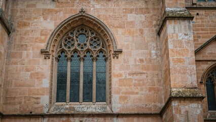 Ornate Gothic-style window on a pastel pink facade