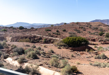 Morocco semi-deserts and mountains, north africa nature, Moroccan stone desert, red hills, villages and argan trees