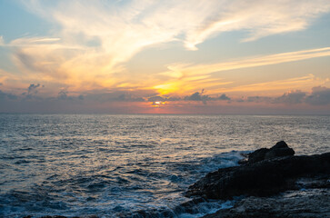 Sunset or sunrise over the sea near rocky coast in Sicily