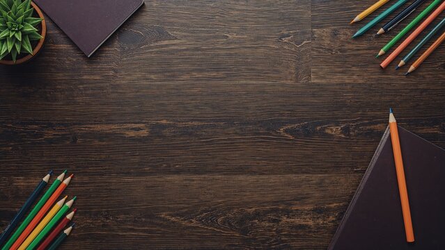 Dark wood desk featuring a pencil container, vibrant pencils, journals, and writing instruments. Theme of learning and returning to classes, stationery, workspace, wood surface, academic setting,