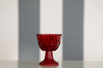 Red glass kitchen containers used for storing food or ingredients, adding a vibrant touch to...