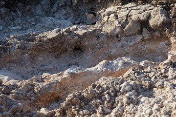 Rocky terrain with uneven surfaces and various textures. Natural geological formations create a...