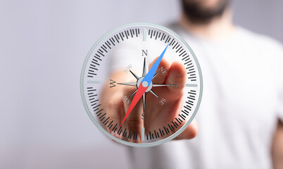 A man interacts with a digital compass, illustrating navigation, direction, and guidance.