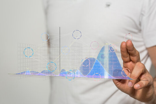 A businessman interacts with a holographic projection of complex data graphs and charts, illustrating data analysis. - Powered by Adobe