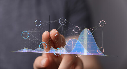 Businessman analyzing data trends on a holographic screen.  Modern technology, data analysis, progress concept.