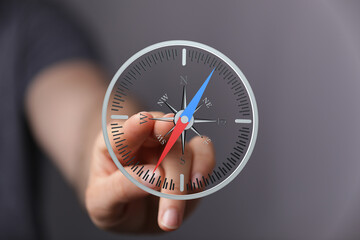 Close-up of a hand interacting with a digital compass, showing direction and navigation.
