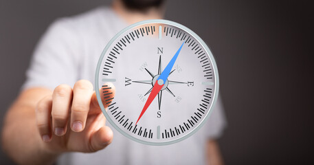 Close-up of a man interacting with a virtual compass, symbolizing guidance, direction, and...