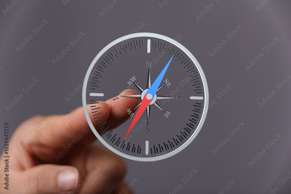 Poster a hand interacts with a digital compass, illustrating navigation and direction finding. ideal for bu