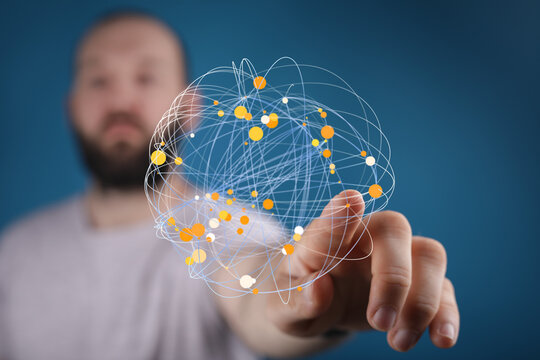 Stock photo of a man touching a digital globe representing connections and data.