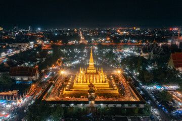 An aerial long exposure shot of the Pha That Luang, a golden stupa in Vientiane, Laos