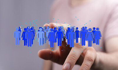 Image depicting a hand interacting with a digital network of people, representing global...