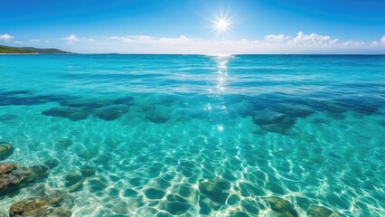 Obraz premium Clear turquoise ocean water with sparkling sunlight reflections and gentle waves under a bright sky. Peaceful tropical seascape with copy space, ideal for summer, travel, tourism, luxury getaway, apps
