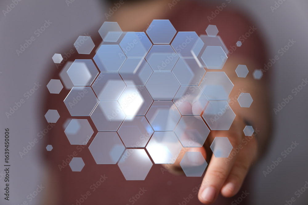 Poster abstract image of hand interacting with a digital hexagon interface. perfect for technology, innovat