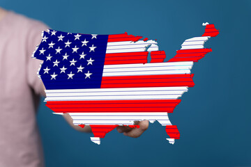 Patriotic image of the USA map designed as an American flag held in a hand.