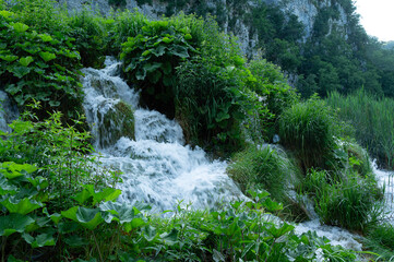 Clear sparkling water with waterfalls and water droplets splashing at Plitvice Lakes, Croatia, Europe.