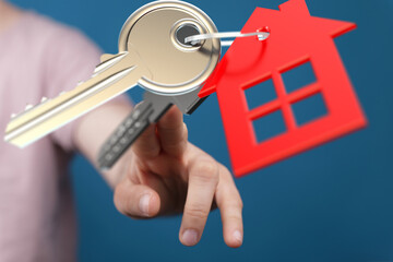 Image of a hand holding house keys, perfect for real estate, home buying, and property concepts.