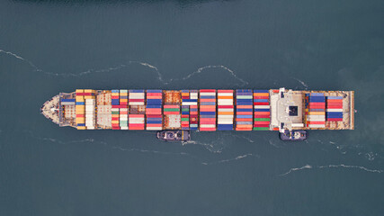 Fototapeta na wymiar Tugboats Shepherd a Giant of Trade