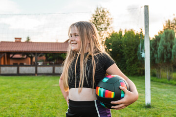 School girl plays volleyball. Summer sports for children,.