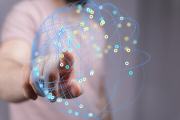 Abstract image of hand interacting with a digital network.  Ideal for technology, connection, and...