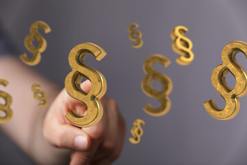 Abstract image of golden paragraph symbols floating, representing legal concepts and law.