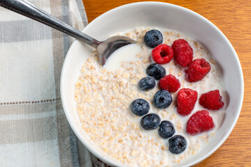 oatmeal top with blue berries and red raspberries