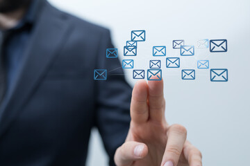 A businessman interacts with a digital network of email icons, showcasing effective communication and online connectivity.