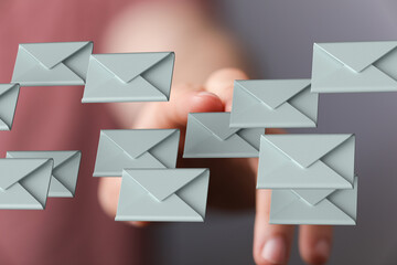 Person interacting with email icons, signifying online communication and digital correspondence.