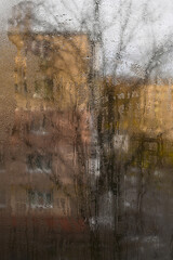vertical wet glass background. Poor ventilation leads to window condensation. Water drops